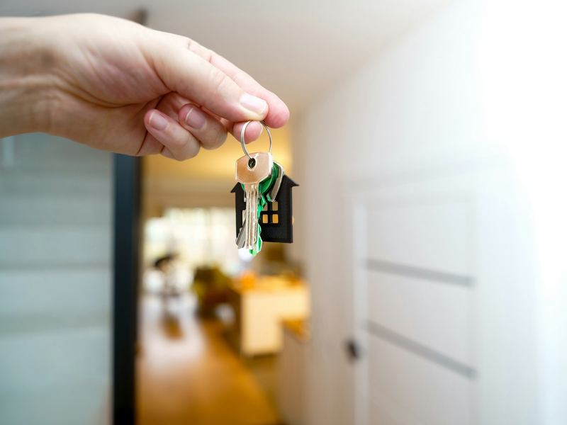 Hand holding house keys