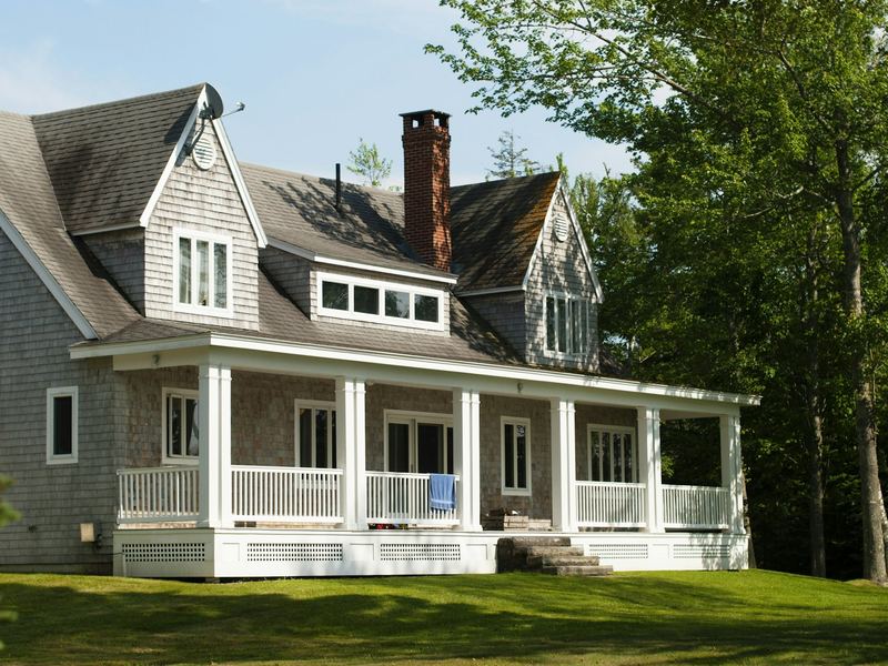 Shingled New England home with a wide front porch